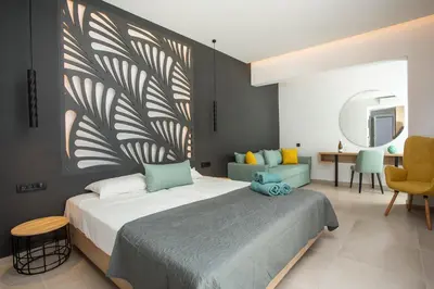 a bedroom with a large bed and a mirror at Casa Stavris in Faliraki