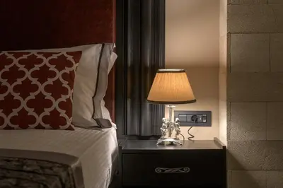 a bedroom with a bed and a lamp on a night stand at Grand Master Suite in Rhodes Town
