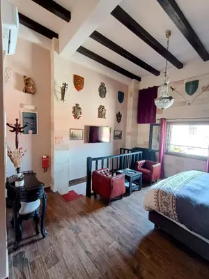 a bedroom with a bed and a desk at Grand Master Suite in Rhodes Town
