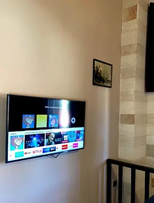 a flat screen tv hanging on a wall at Grand Master Suite in Rhodes Town