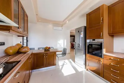 a kitchen with wooden cabinets and a counter top at Lucia's Secret Garden in Asgourou