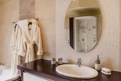 a bathroom with a sink and a mirror at Lucia's Secret Garden in Asgourou