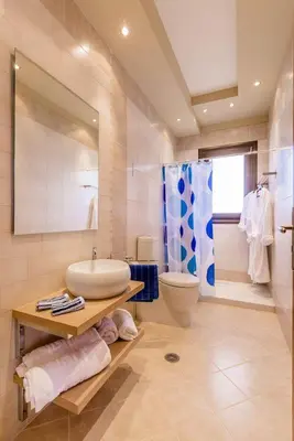 a bathroom with a sink and a toilet and a shower at Lucia's Secret Garden in Asgourou