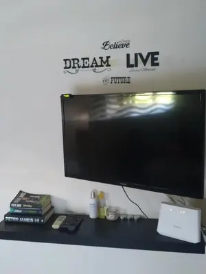 a flat screen tv sitting on top of a desk at Holiday Nest & parking in Ialyssos