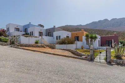 a row of houses on the side of a road at Stefanakis Villas - Car Included in Livadia