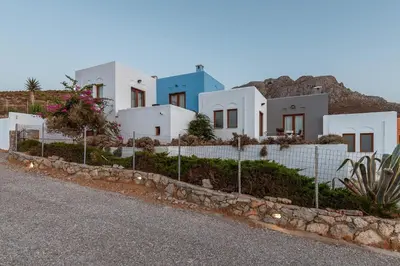 a row of white houses on the side of a road at Stefanakis Villas - Car Included in Livadia