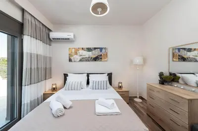 a bedroom with a bed with two towels on it at Sun's Reach Villa in Rhodes Town