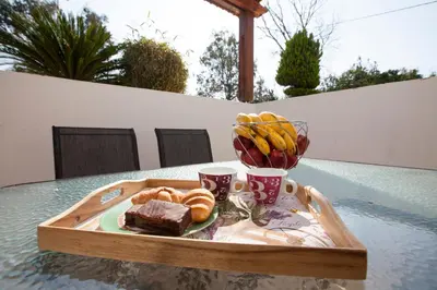 a tray with a plate of bread and a bowl of fruit at Natural Quiet Accommodation in Kallithea Rhodes