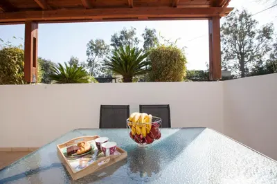a glass table with a bowl of fruit on it at Natural Quiet Accommodation in Kallithea Rhodes