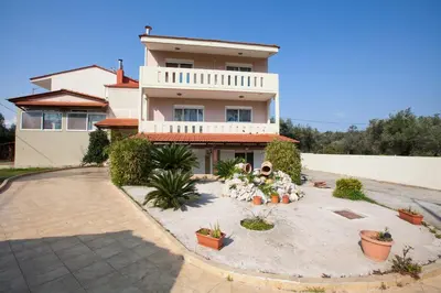 a house with a courtyard in front of it at Natural Quiet Accommodation in Kallithea Rhodes