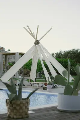 a white triangular tent next to a swimming pool at LA Casa Di Lusso N4 - Adults Only in Kolimbia