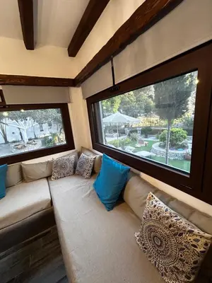 a couch in a room with two large windows at Aithonas Villa in Archangelos