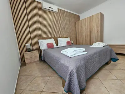 a bedroom with a bed with towels on it at Faliraki Holidays in Faliraki