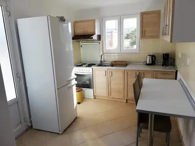 a kitchen with a white refrigerator and a table at Faliraki Holidays in Faliraki
