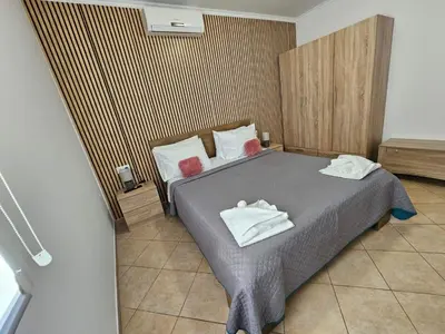 a bedroom with a bed with two towels on it at Faliraki Holidays in Faliraki