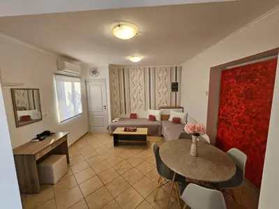 a living room with a couch and a table at Faliraki Holidays in Faliraki