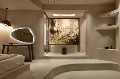 a bathroom with a shower and a large painting on the wall at Stone Luxury Suites - Adults Only in Archangelos
