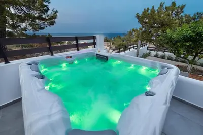 a swimming pool on the back of a house at ANASTASIOS HOUSE STEGNA in Archangelos