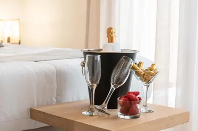 a table with two wine glasses and a bowl of fruit at ANASTASIOS HOUSE STEGNA in Archangelos