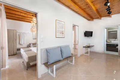 a large living room with a couch and a television at ANASTASIOS HOUSE STEGNA in Archangelos