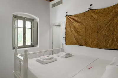 a bedroom with a bed with two towels on it at Mami`s House with Private Pool in Pefki Rhodes