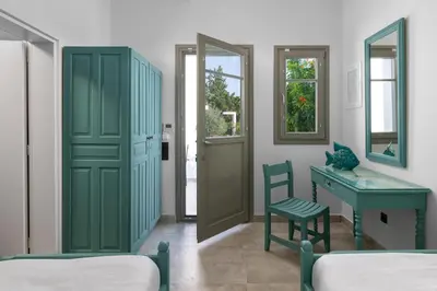 a room with a green door and a desk and a chair at Mami`s House with Private Pool in Pefki Rhodes