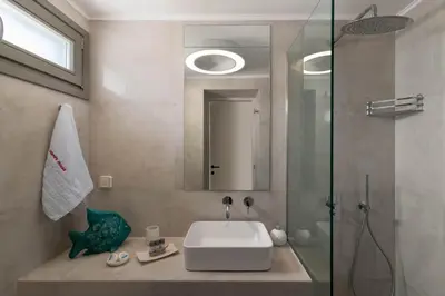 a bathroom with a sink and a glass shower at Mami`s House with Private Pool in Pefki Rhodes
