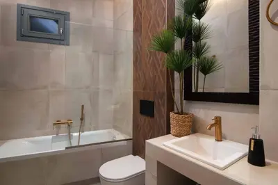 a bathroom with a toilet and a sink and a tub at Mami`s House with Private Pool in Pefki Rhodes