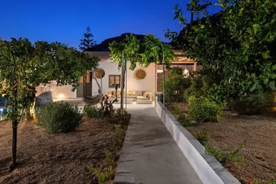 a walkway in front of a house at night at Mami`s House with Private Pool in Pefki Rhodes