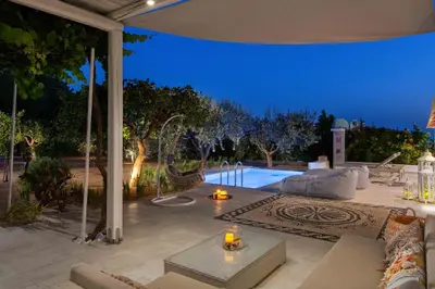 an outdoor patio with a pool at night at Mami`s House with Private Pool in Pefki Rhodes