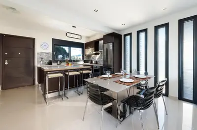 a kitchen with a table and chairs in a kitchen at Ixia Breeze 1 in Ixia