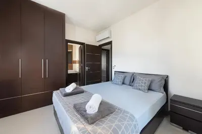 a bedroom with a bed with two towels on it at Ixia Breeze 1 in Ixia