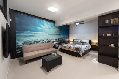 a bedroom with a bed and a large painting on the wall at Ixia Breeze 1 in Ixia