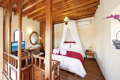 a bedroom with a bed with a canopy at In Camera Art Boutique Hotel in Rhodes Town