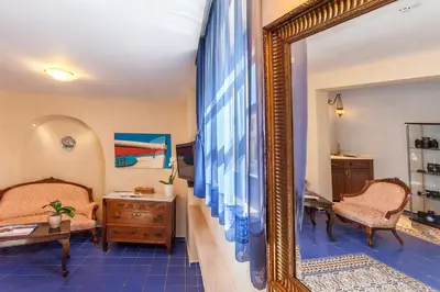 a room with a mirror and a bed and a desk at In Camera Art Boutique Hotel in Rhodes Town