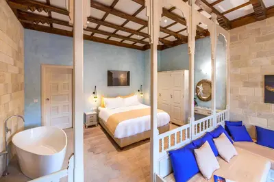 a bedroom with a bed and a tub in a room at In Camera Art Boutique Hotel in Rhodes Town