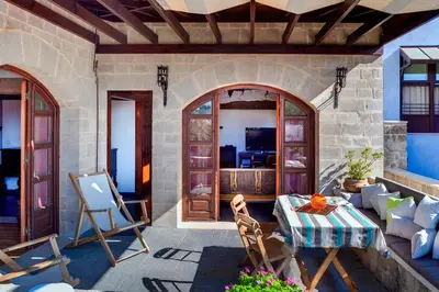 a patio with a table and chairs and a couch at In Camera Art Boutique Hotel in Rhodes Town