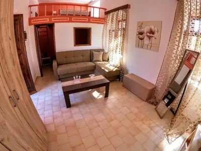 a living room with a couch and a table at Armonia House in Symi