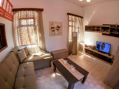 a living room with a couch and a table at Armonia House in Symi