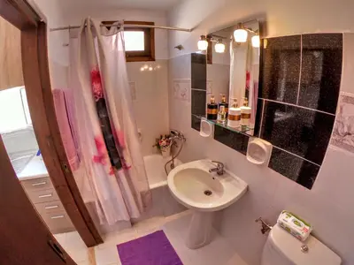 a bathroom with a sink and a shower and a toilet at Armonia House in Symi