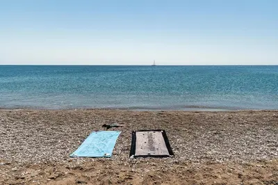 a pair of boards on a beach with the water at House Myrtos in Lachania
