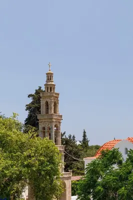 a building with a clock tower in the background at House Salvia in Lachania