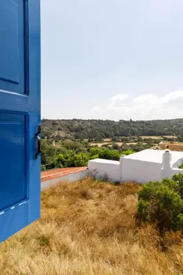 a blue door with a view of a building at House Salvia in Lachania