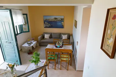 a living room with a table and a couch at House Almyra in Lachania