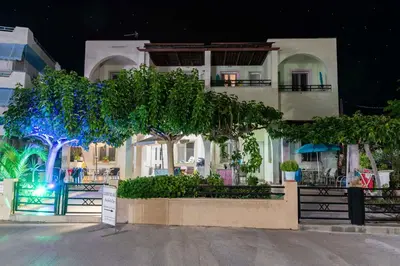 a building with trees in front of it at night at Haraki Sand Beach in Haraki