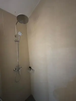 a shower in a corner of a bathroom at Haraki Beauty in Haraki