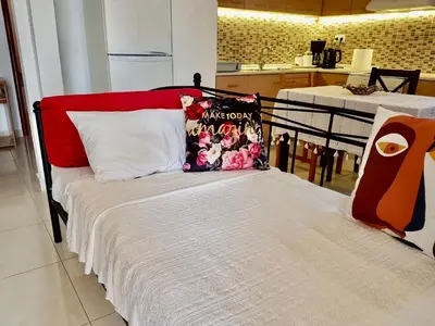 a bed with a pillow on it in a room at The Metropolis Residence Rhodes in Rhodes Town