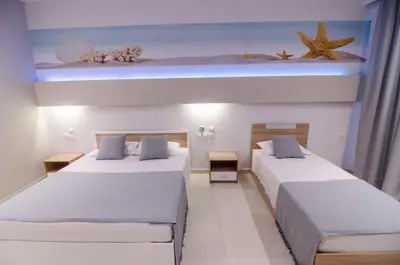 two beds in a room with two beds sidx sidx sidx sidx at Galazio Beach in Faliraki