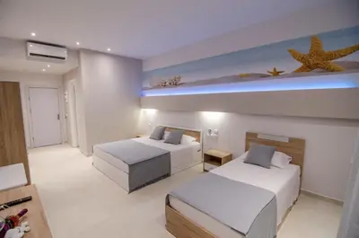 a bedroom with two beds and a starfish on the wall at Galazio Beach in Faliraki