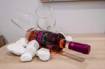 a bottle of wine sitting on top of a table at Galazio Beach in Faliraki